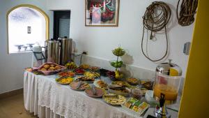 a table with many plates of food on it at Hostal La Magia de Uyuni in Uyuni