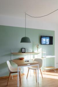 a dining room with a table and two chairs at Hus Appartement - Nr. 1 in Valdaora