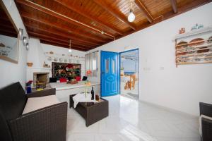 a living room with a blue door and a fireplace at Endless Blue Stegna in Archangelos
