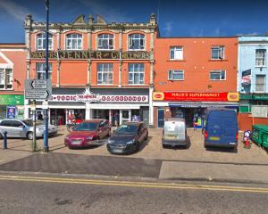 a group of cars parked in a parking lot in front of a building at Bristol City Budget Studio Stay in Bristol