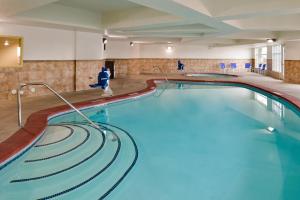 a swimming pool in a hotel room with a swimming pool at Holiday Inn Express & Suites Nampa - Idaho Center, an IHG Hotel in Nampa