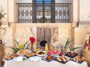 a table filled with food on top of a table at Palazzo Daniele, a Member of Design Hotels in Gagliano del Capo