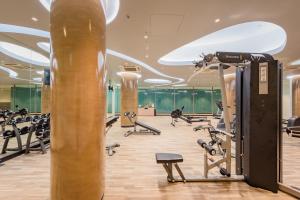 a gym with tread machines and a column at Oceanfront Beach Resort - SHA Extra Plus in Patong Beach