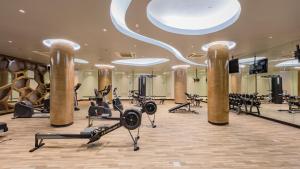 a gym with treadmills and exercise equipment in a building at Oceanfront Beach Resort - SHA Extra Plus in Patong Beach