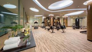 a gym with treadmills and elliptical machines at Oceanfront Beach Resort - SHA Extra Plus in Patong Beach