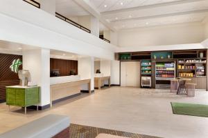 a lobby of a hotel with a library at Holiday Inn Houston Intercontinental Airport by IHG in Houston