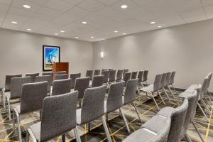 a conference room with rows of chairs and a podium at Holiday Inn Houston Intercontinental Airport by IHG in Houston