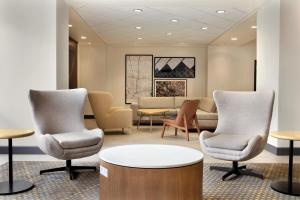 a waiting room with chairs and a table at Holiday Inn Houston Intercontinental Airport, an IHG Hotel in Houston