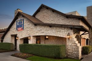 a large stone building with a sign on it at Holiday Inn Houston Intercontinental Airport by IHG in Houston