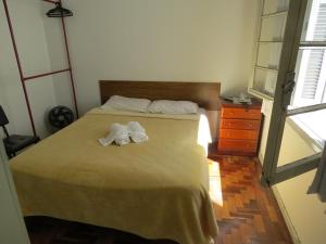 a bedroom with a bed with towels on it at City Hotel in Caxias do Sul