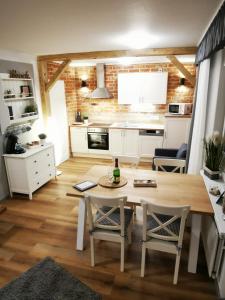 a kitchen and dining room with a table and chairs at Auszeit Norddeich in Norddeich