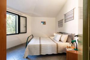 サンタ・マリア・ナヴァッレゼにあるCase Vacanza Masoniaiのベッドルーム(ベッド1台、窓付)