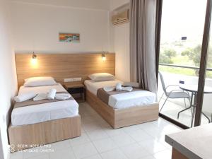 Postel nebo postele na pokoji v ubytování Sotirakis Hotel