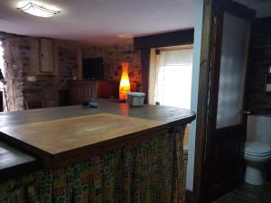 a kitchen with a wooden counter top and a toilet at Casa Do Ivi in Yermo +143 photos