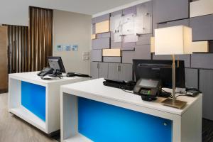 a desk with two monitors and a laptop on it at Holiday Inn Express & Suites New Braunfels, an IHG Hotel in New Braunfels
