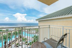 a balcony overlooking a beach with a view of the ocean at Omni Amelia Island Resort in Amelia Island