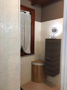 a bathroom with a shower with a vanity and a mirror at Panorama Penthouse con giardino privato in Santadi +31 photos