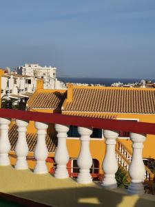 a balcony with white columns and a view of a building at Ocean View Lagos in Lagos