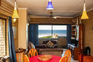 a living room with a view of the ocean at Seven Seas SA in Amanzimtoti