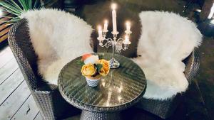 a glass table with two chairs with white faux fur at Hotel Jolanda in Santa Margherita Ligure