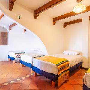 a bedroom with two beds in a room at Acoma in Otavalo