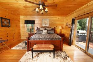 a bedroom with a bed in a log cabin at Majestic Manor Cabin in Waldens Creek