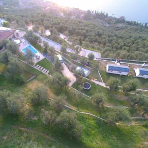 an aerial view of a yard with a house and a pool at Agricampeggio Relax Maxicaravan in Castelletto di Brenzone