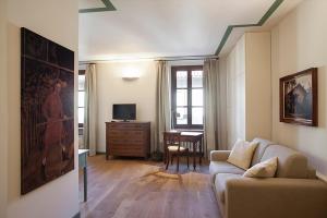 a living room with a couch and a table at Borromeo Rooms Bed & Living in Vimercate