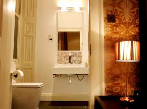 a bathroom with a sink and a mirror at Boutique 25 in Skipton