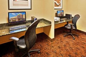 an office with two desks with a computer and two chairs at Holiday Inn Express Hotel & Suites Bartlesville, an IHG Hotel in Bartlesville