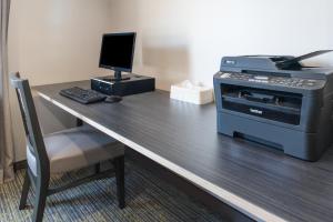 a desk with a computer and a printer on it at Holiday Inn Express Hotel & Suites Burlington, an IHG Hotel in Burlington