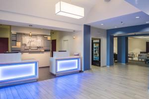 an empty lobby with a kitchen and a dining room at Holiday Inn Express Hotel & Suites Burlington, an IHG Hotel in Burlington