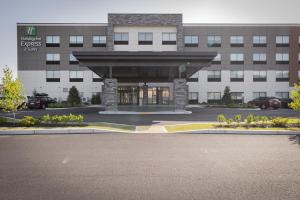 a building with a parking lot in front of it at Holiday Inn Express & Suites - Boston South - Randolph by IHG in Randolph