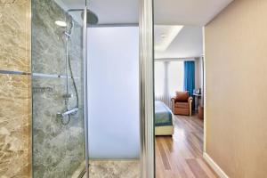 a bathroom with a shower and a walk in shower at Great Fortune Hotel & Spa in Istanbul