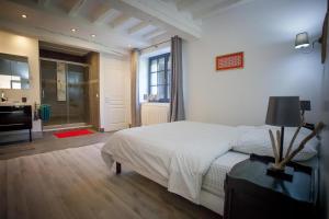 a bedroom with a bed and a bathroom at La Belle Landaise 1809 Gîte Arridoulet 1 in Peyrehorade +47 photos