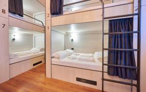a room with two bunk beds and a mirror at SECRET boutique Hostel in Braşov