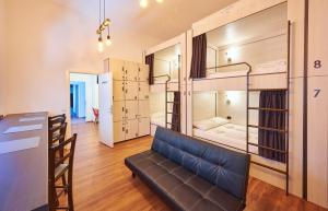 a room with a couch and a room with bunk beds at SECRET boutique Hostel in Braşov