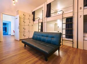 a black leather couch in a room with many shelves at SECRET boutique Hostel in Braşov