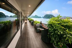 a balcony on a cruise ship with a view of the water at Alisa Cruise Halong in Ha Long