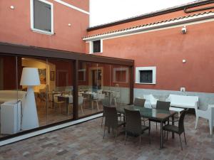 a patio with a table and chairs and a building at Taverna Ferrigno in Padula