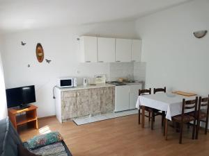 a kitchen and dining room with a table and a table and chairs at Apartments S&M in Marina
