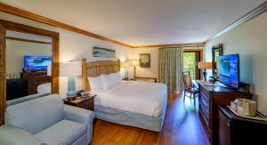 a hotel room with a bed and a television at Lanier Islands Legacy Lodge in Buford