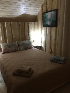 a bedroom with a bed with two towels on it at Володар in Yaremche