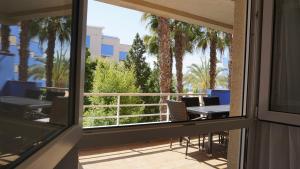 a view from a window of a patio with palm trees at CALAS AGUAMARINA - Campoamor - Primera Linea in Campoamor