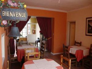 a dining room with two tables and a sign that reads brewery at Petite Maison in Quito