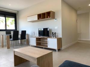 a living room with a tv and a table at Baja B Beauty, Lo Pagan in Murcia