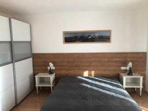 a bedroom with a bed and two night stands at Appartamento Incanto in Valdaora
