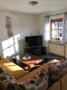 a living room with a couch and a coffee table at Ferienwohnung Magdalena in Bodenmais