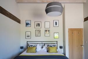 a bedroom with a bed with yellow and blue pillows at Willow Barn Norfolk Broads B&B in Stokesby