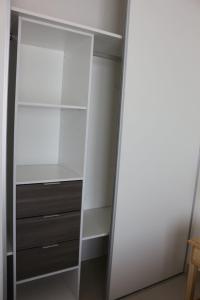 a closet with a mirror and a white cabinet at Departamento nuevo y luminoso en el centro. in La Rioja